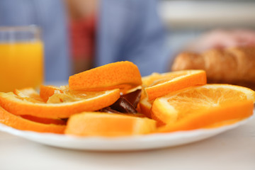 Orange sliced slices on a plate on a kitchen