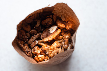 The peeled walnut kernels are packaged by weight in an eclogical paper bag.