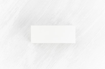 White blank closed paper rectangle box mock up on soft light white wood board top view for design, branding identity, advertising, presentation.