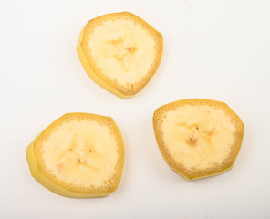 Three slices of ripe yellow banana on a white background. Close up.
