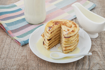 Breakfast pancakes with milk and maple syrup