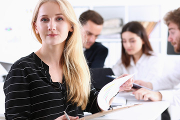 Beautiful smiling cheerful girl at workplace