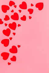Valentine's Day design. Red hearts frame on pink background top-down copy space