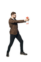 An attractive man with a beard in a suit holding a white chemical spray bottle.   Special agent of purity isolated on a white background. 