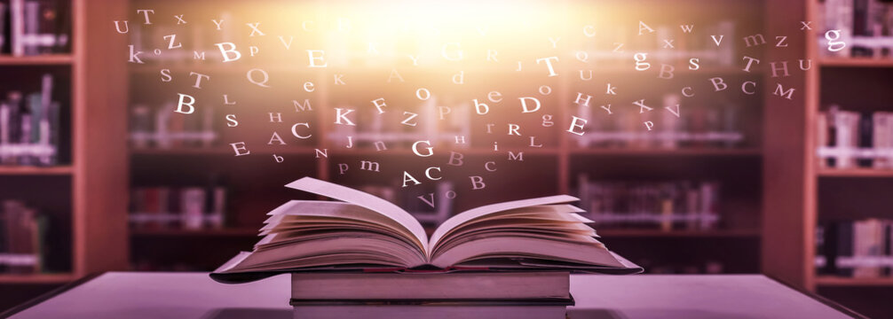 Imagine opening an old book blurred with magic power on the table and the  English alphabet floating above the book with magic light as a beautiful background  design. Stock Photo | Adobe