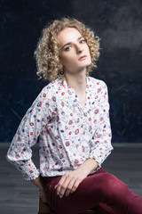 A portrait young blond man androgyne in the image of an attractive woman