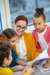 Children learning English grammar with their teacher