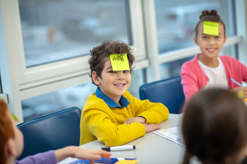 Schoolboy smiling trying to guess the English word