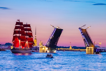 Saint Petersburg. Russia. White nights in St. Petersburg. Festive Scarlet sails. A ship with scarlet sails on the Neva. Brigantine on the background of the divorced Trinity bridge. Petropavlovskaya