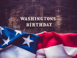 Washington's Birthday, Presidents' Day. Beautiful greeting card. Brown, isolated background, close-up, top view, wooden surface. Congratulations for relatives, friends and colleagues