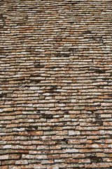 Texture of terracota tiles. Old weathered tile roof background