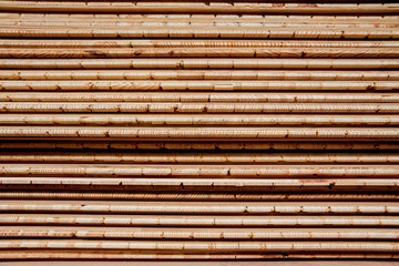 Stack of natural rough wooden boards. Wooden boards, lumber, industrial wood.