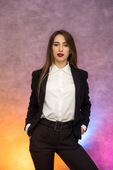 Business concept. Stylish businesswoman in elegant suit posing on abstract background © RomanR