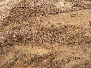 Soil on the ground as texture and background. Top view shot