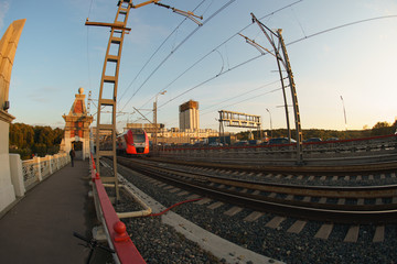 Photography of the train of Moscow Central Circle or MCC. Fashionable and comfortable Lastochka commuter train in the motion. Fish Eye lens.