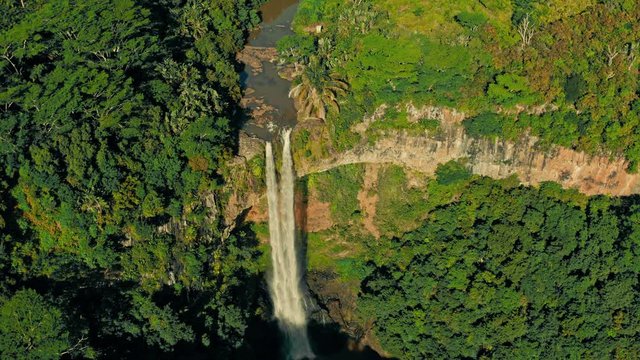 Flying over with Top Down Camera of the Chamarel Waterfall at the Mauritius Island during Sunset.