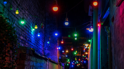 Fototapeta na wymiar Multi-colored light bulbs create a festive mood. Abstract background for birthday, anniversary, wedding, new year eve or Christmas