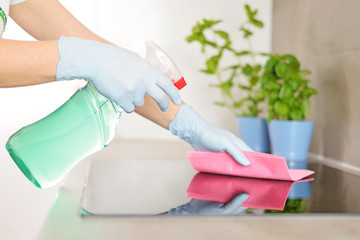 Woman in gloves cleaning kitchen. - obrazy, fototapety, plakaty