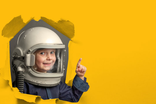 Small child wants to fly an airplane wearing an airplane helmet