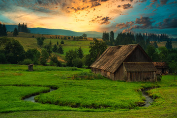 Wood cabin on the meadow