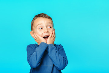 a model child posing on turquoise background