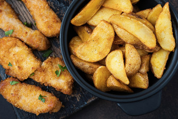 Close-up crispy chicken and potatoes