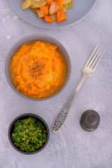 Mashed sweet in plate with steamed vegetables and glamorata