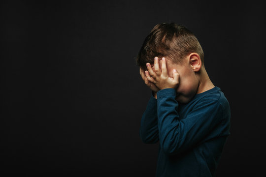 child whose depression is on a black background