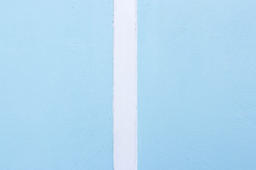 The blue cement wall contrasts with the white color.