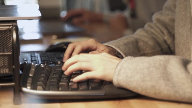 This is a person coding and typing on a nice keyboard at work.