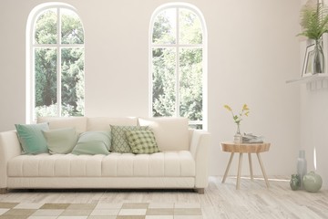 Stylish room in white color with sofa and summer landscape in window. Scandinavian interior design. 3D illustration