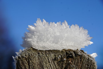 Eiskristalle in der Natur auf Zaunpfosten