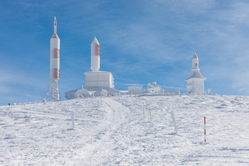 TV and radio antennas known as La Bola del Mundo in Navacerrada, Madrid, Spain, on a snow-covered mountain.