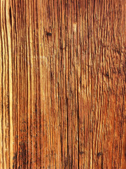 Detail and close-up view of a rustic, aged wooden facade with pronounced longitudinal cracks and columns.