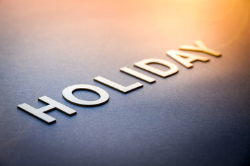 Fototapeta premium Word holiday written with white solid letters
