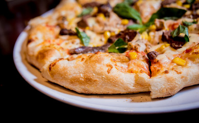 Tasty pizza with chicken and vegetables. Restaurant.