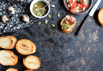 Italian tomato bruschetta with chopped vegetables, herbs and oil on grilled or toasted crusty ciabatta bread. Food photography. Flat lay concept.