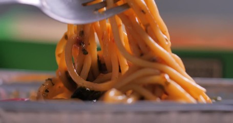 Close-up shot the fork picking hot and spicy spaghetti Italian food select focus shallow depth of field - Powered by Adobe
