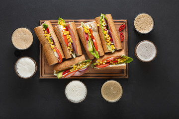 Tasty sandwiches of ham and beer, top view.