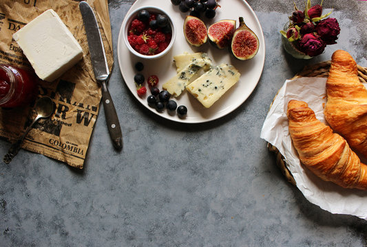 French breakfast. Cheese plate with grapes, figs and berry. Wine snaks. Top view with copy space. Flat lay concept.