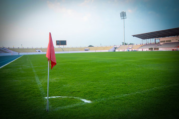 Obraz premium The flagpole is located at Conner football field. the green field in stadium