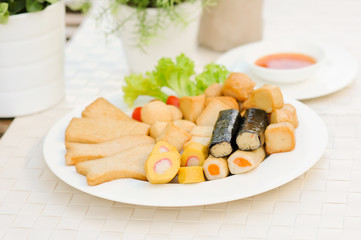 Appetizers, Meat ball , fish ball and sausage with sauce on white dish