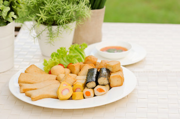 Appetizers, Meat ball , fish ball and sausage with sauce on white dish