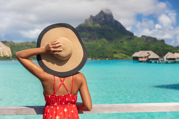 Beach vacation tourist woman looking at view of Mt Otemanu on Bora Bora luxury resort island on...