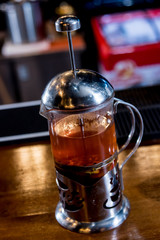 Tea in a glass teapot at bar counter. Restaurant. Nightlife