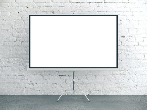 Blank white poster in brick interior room.