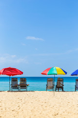 Fototapeta na wymiar Vacation time, Relaxing at the beach, summer outdoor day light, Thailand holiday destination, colorful beach umbrella with beach chairs on the beach