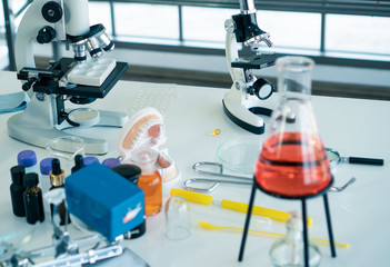 The microscope is located in the scientist's room.