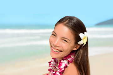 Hawaii luau hula dancer woman happy wearing flower lei on vacation beach travel tropical honeymoon...