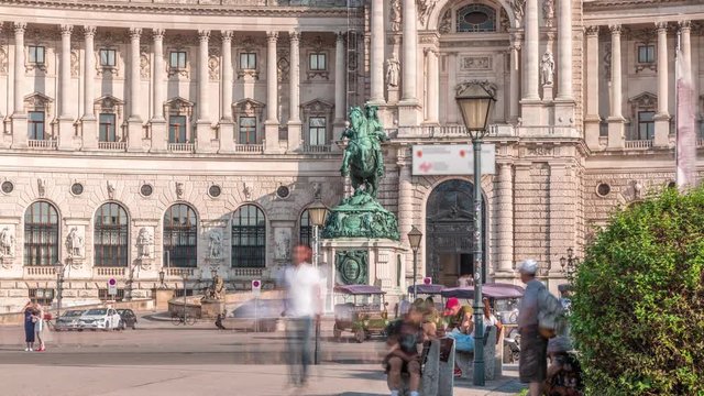 Equestrian statue of Prince Eugene of Savoy timelapse (Prinz Eugen von Savoyen) in front of Hofburg palace, Heldenplatz, Vienna, Austria. People walking around